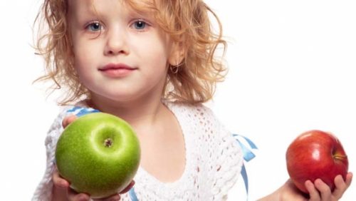 girl holding two apples