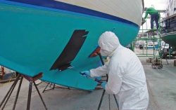 A man was asked to paint a boat.