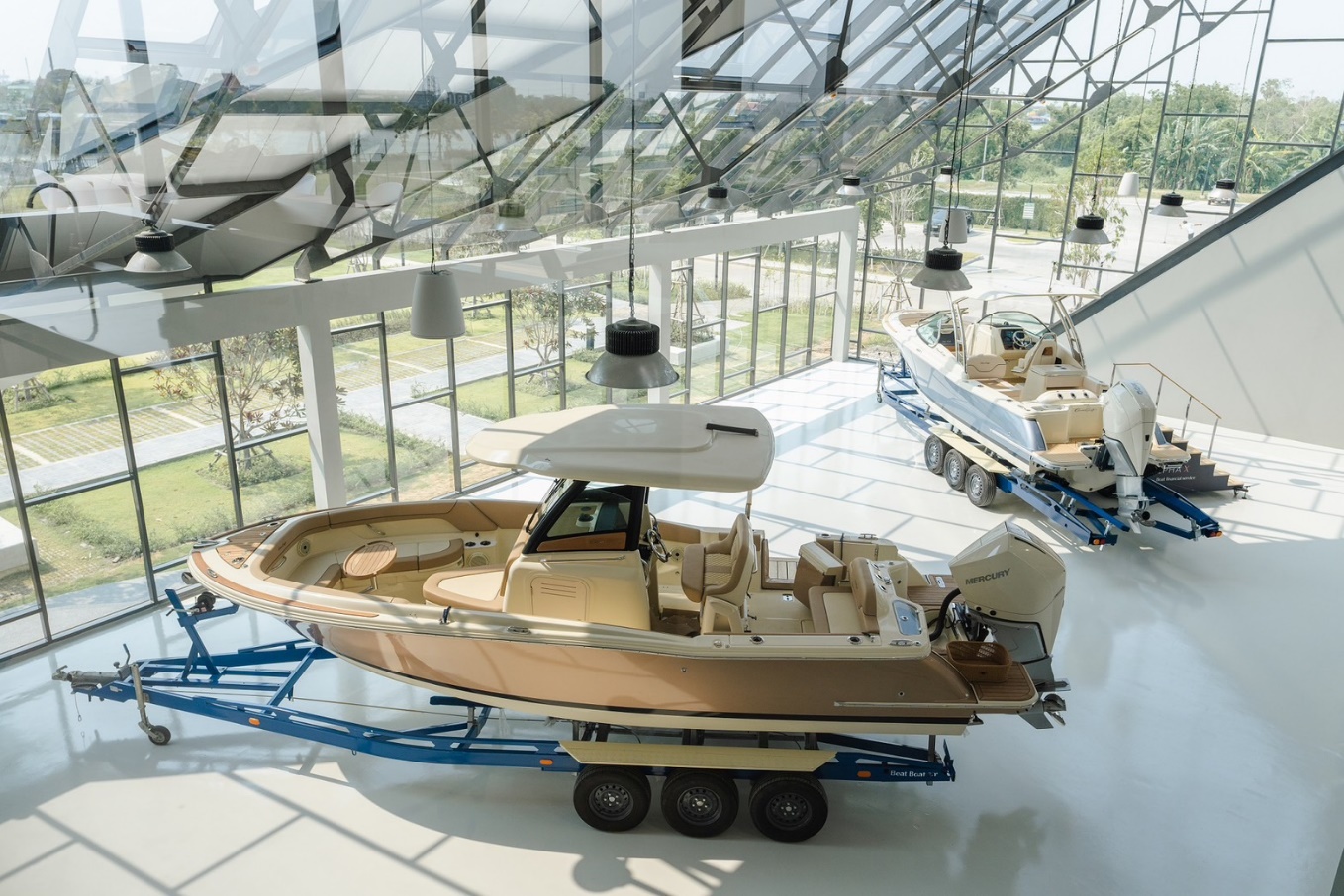 New Chris-Craft showroom and service center at Riverdale Marina near Bangkok, Thailand, with Calypso 24 (top) and Catalina 24 (bottom) models on display.