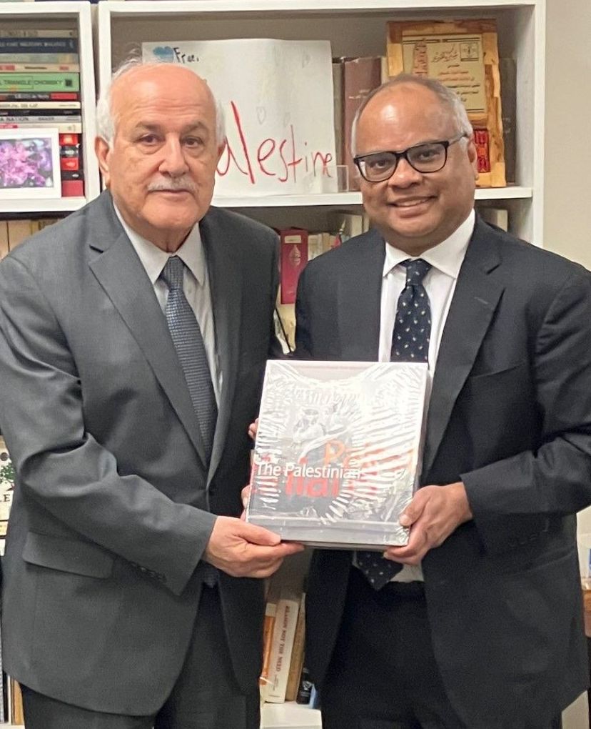 His Excellency Ambassador Riad Mansour of Palestine handing over a gift of a precious book on Palestine to AUW Founder Mr. Kamal Ahmad.