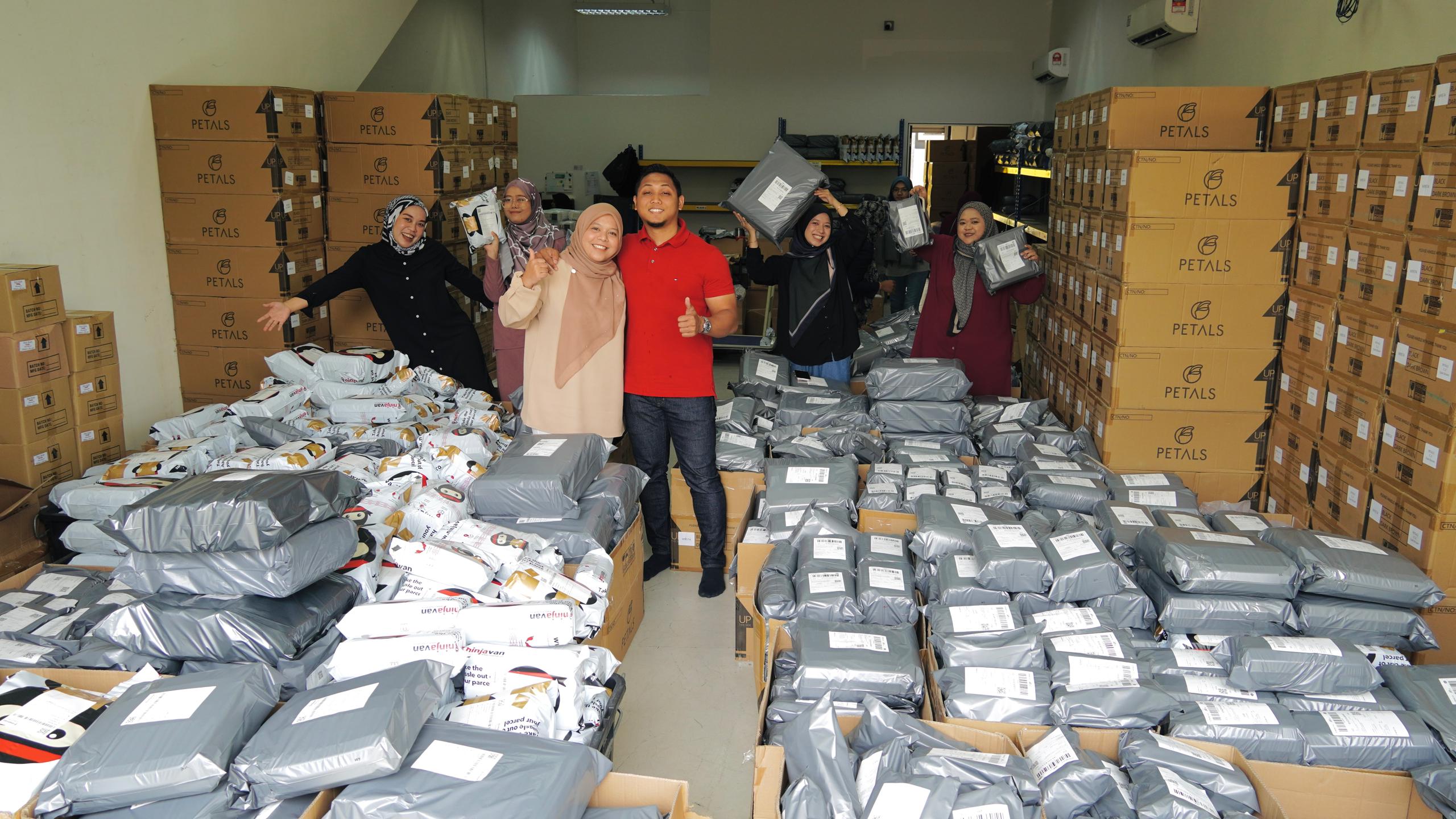 Khairul Azman, founder of Petals Malaysia with staff ready to deliver customers' parcels.